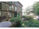 Charming two-story condo with lush landscaping and inviting green doors and walkways at 3907 Cedar Cir, Tucker, GA 30084