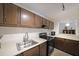 Efficient kitchen features wooden cabinetry, white countertops, and modern black appliances at 3907 Cedar Cir, Tucker, GA 30084