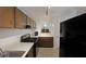 Well-equipped kitchen boasts neutral countertops, black appliances, and convenient breakfast bar at 3907 Cedar Cir, Tucker, GA 30084