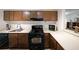 Cozy kitchen featuring dark cabinets, black appliances, and an open layout for easy access at 3907 Cedar Cir, Tucker, GA 30084