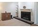 Living room featuring a fireplace, built-in shelving, and a sleek robot vacuum cleaner at 3907 Cedar Cir, Tucker, GA 30084