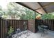 Spacious patio featuring a metal table set, plants, and a peaceful view of the wooded surroundings at 3907 Cedar Cir, Tucker, GA 30084