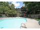 Community pool with ample lounge seating, picnic area, and manicured landscaping at 3907 Cedar Cir, Tucker, GA 30084