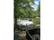 Community pool surrounded by trees, fencing, and lounge chairs, offering a refreshing escape at 3907 Cedar Cir, Tucker, GA 30084