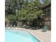 Community pool with lounge chairs, nestled within mature trees and stone retaining walls at 3907 Cedar Cir, Tucker, GA 30084