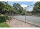 A fenced community tennis court surrounded by lush trees and nature at 3907 Cedar Cir, Tucker, GA 30084