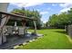 Cozy backyard patio area with comfortable seating under a gazebo, perfect for outdoor dining and relaxation at 5010 Amber Leaf Dr, Roswell, GA 30076