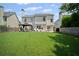 Spacious backyard with manicured lawn, patio area, and inviting gazebo creating an ideal outdoor retreat at 5010 Amber Leaf Dr, Roswell, GA 30076