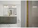 Bathroom featuring double sinks, marble floors, and a glass shower door at 5010 Amber Leaf Dr, Roswell, GA 30076