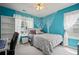 Turquoise bedroom with a decorative tree mural, shelving, white curtains, and a desk at 5010 Amber Leaf Dr, Roswell, GA 30076