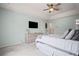 A bright bedroom with a ceiling fan, tv, walk-in closet, and a comfortable queen-sized bed at 5010 Amber Leaf Dr, Roswell, GA 30076