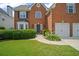 Charming brick home with a well-manicured lawn and two-car garage at 5010 Amber Leaf Dr, Roswell, GA 30076