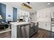 Modern kitchen featuring a farmhouse sink, stainless steel appliances, and white cabinetry at 5010 Amber Leaf Dr, Roswell, GA 30076