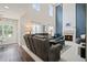 Spacious living room featuring a fireplace, two story windows, and comfortable seating at 5010 Amber Leaf Dr, Roswell, GA 30076