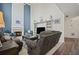 Living room featuring a fireplace, shelving, wood floors, two story windows, and a high vaulted ceiling at 5010 Amber Leaf Dr, Roswell, GA 30076