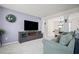 Inviting living room with soft carpeting and a large entertainment center at 5010 Amber Leaf Dr, Roswell, GA 30076