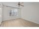 Bright bedroom with ceiling fan, light wood floors, and window at 5207 Santa Fe Pkwy, Sandy Springs, GA 30350