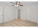 Bedroom showcasing light wood floors, a ceiling fan, and white trim at 5207 Santa Fe Pkwy, Sandy Springs, GA 30350
