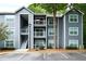 Exterior of a three-story apartment building with gray siding and white trim at 5207 Santa Fe Pkwy, Sandy Springs, GA 30350