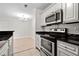 Modern kitchen featuring white cabinets, black countertops and stainless steel appliances at 5207 Santa Fe Pkwy, Sandy Springs, GA 30350