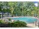 Community pool surrounded by lush trees and lounge chairs, perfect for relaxation at 5207 Santa Fe Pkwy, Sandy Springs, GA 30350