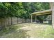 Spacious backyard with a covered patio, privacy fence, and lush green lawn at 5696 Walnut Mill Ln, Powder Springs, GA 30127