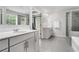 Bright bathroom featuring dual vanities, a glass-enclosed shower, and modern fixtures throughout the relaxing space at 5696 Walnut Mill Ln, Powder Springs, GA 30127
