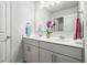 Neutral-toned bathroom with double sink vanity, white cabinets, and a large mirror at 5696 Walnut Mill Ln, Powder Springs, GA 30127