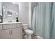 Bathroom with vanity, mirror, toilet and shower/tub with curtain at 5696 Walnut Mill Ln, Powder Springs, GA 30127