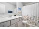 Bright bathroom featuring a single sink vanity, white cabinets, and a shower curtain at 5696 Walnut Mill Ln, Powder Springs, GA 30127
