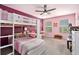 Pink bedroom with a bunk bed, ceiling fan, carpet, and natural light from the two windows at 5696 Walnut Mill Ln, Powder Springs, GA 30127