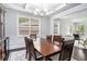 Elegant dining room with a coffered ceiling, a large window, and seating for six at 5696 Walnut Mill Ln, Powder Springs, GA 30127
