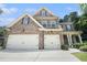 Charming two-story brick home with a well-manicured lawn and a two-car garage, providing ample space at 5696 Walnut Mill Ln, Powder Springs, GA 30127