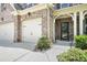 Close-up of the inviting front entrance with a decorative door and a well-manicured garden at 5696 Walnut Mill Ln, Powder Springs, GA 30127