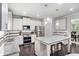 Modern kitchen with white cabinets, stainless steel appliances, granite countertops, and an island with seating at 5696 Walnut Mill Ln, Powder Springs, GA 30127