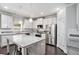 Well-lit kitchen with white cabinets, stainless steel appliances, granite countertops and island with breakfast bar at 5696 Walnut Mill Ln, Powder Springs, GA 30127