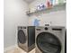 Laundry room with side-by-side washer and dryer and shelving at 5696 Walnut Mill Ln, Powder Springs, GA 30127