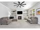 Cozy living room featuring a fireplace, built-in shelves, a ceiling fan, and plush seating at 5696 Walnut Mill Ln, Powder Springs, GA 30127