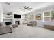 Inviting living room featuring a fireplace, built-in shelves, plush seating, and natural light from the windows at 5696 Walnut Mill Ln, Powder Springs, GA 30127