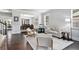 Bright living room with hardwood floors, neutral paint, and comfortable seating, adjacent to the dining room at 5696 Walnut Mill Ln, Powder Springs, GA 30127