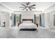 Spacious carpeted main bedroom with bed, ceiling fan, and ensuite bath at 5696 Walnut Mill Ln, Powder Springs, GA 30127