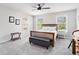 Neutral-toned bedroom with carpeted floors, a ceiling fan, and natural light from the windows at 5696 Walnut Mill Ln, Powder Springs, GA 30127