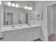 Bathroom featuring double sinks with modern fixtures and a large, well-lit mirror at 6179 Ashbranch Dr, Acworth, GA 30101