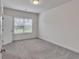 Neutral bedroom with large window offering natural light, gray carpet, and white trim at 6179 Ashbranch Dr, Acworth, GA 30101