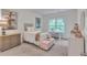 Cozy bedroom featuring a window view, neutral decor, and stylish decor at 6179 Ashbranch Dr, Acworth, GA 30101