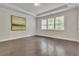 Spacious bedroom with hardwood floors, tray ceiling, and natural light at 6179 Ashbranch Dr, Acworth, GA 30101