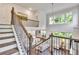 A view from the staircase overlooks the great room with large bright windows and an open floor plan at 6179 Ashbranch Dr, Acworth, GA 30101