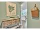 Hallway features console table, botanical art, and decorative basket at 6179 Ashbranch Dr, Acworth, GA 30101