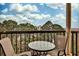 Balcony with a table and chairs overlooking green treetops and buildings at 1 Biscayne Drive Nw # 706, Atlanta, GA 30309