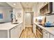 Well-lit kitchen features white cabinetry, stainless steel appliances, quartz counters, and a breakfast bar at 1 Biscayne Drive Nw # 706, Atlanta, GA 30309